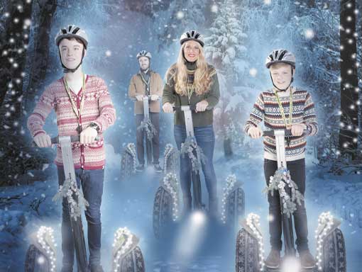 A family riding segways through a magical Christmas forest A family riding segways through a magical Christmas forest